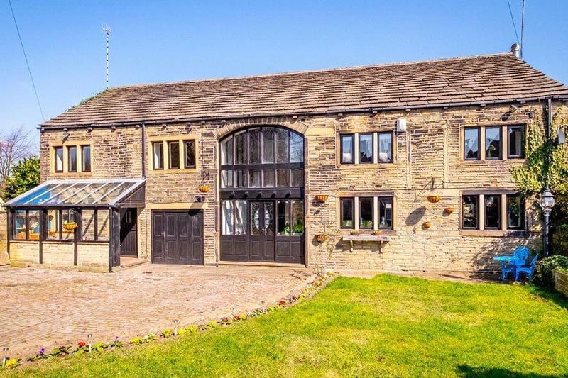This magnificent five bedroom barn conversion in Rastrick, Huddersfield, is full of charm and character. It offers a large open plan dual aspect living room, coutnry kitchen with Aga and pantry, converted attic and a large garden with stunning views. The vendor has also to pay stamp duty costs over 500,000. It is on the market with Dacre, Son & Hartley for offers over 600,000.
