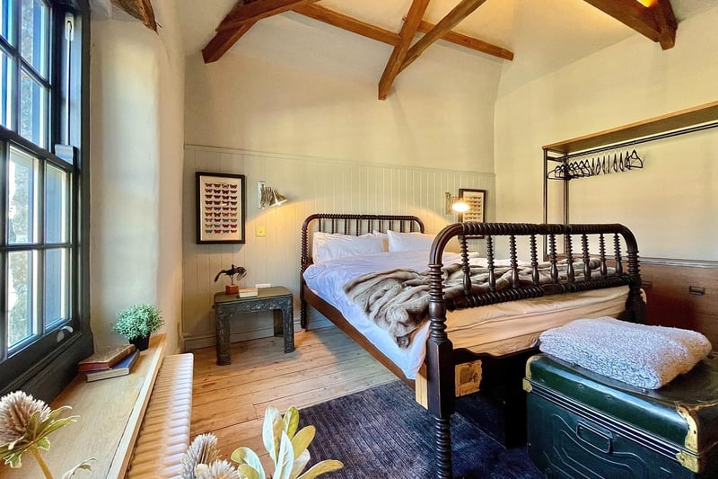 One of the three double bedrooms with a rare Jenny Lind bed and exposed beams and trusses