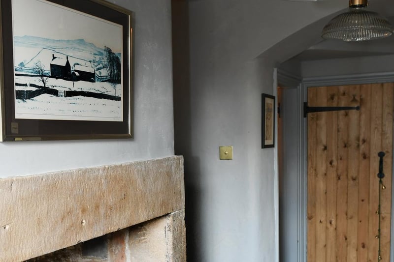 This print is of artist Peter Brook's painting of Hanah Hauxwell on her farm, Low Birk Hatt. It now has a prominent place above theinglenook in the spacious hallway.