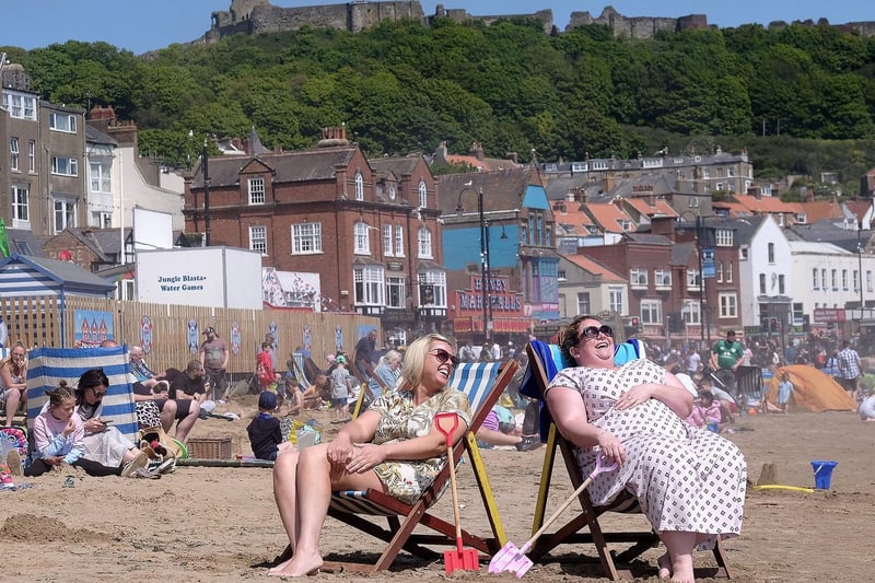 Two women relax on deck chairs as the sun finally shines down on Yorkshire