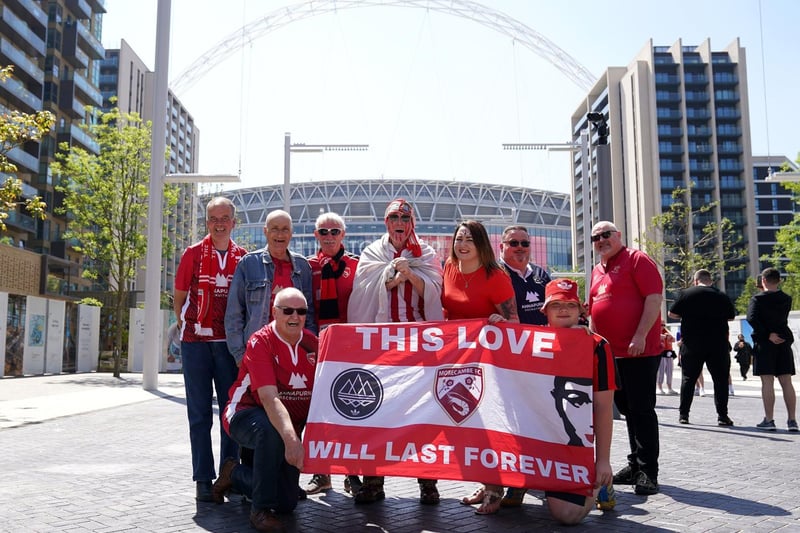 Shrimps fans gather together to pose with a banner under the famous Wembley arch.