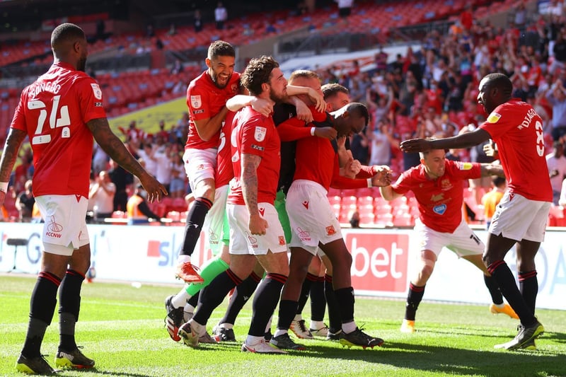 Morecambe's players celebrate after Carlos Mendes Gomes' penalty
