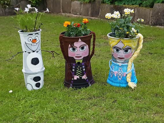 Here's just three of the plant pot characters people can see on the Brindle Gregson Lane in Bloom Trail