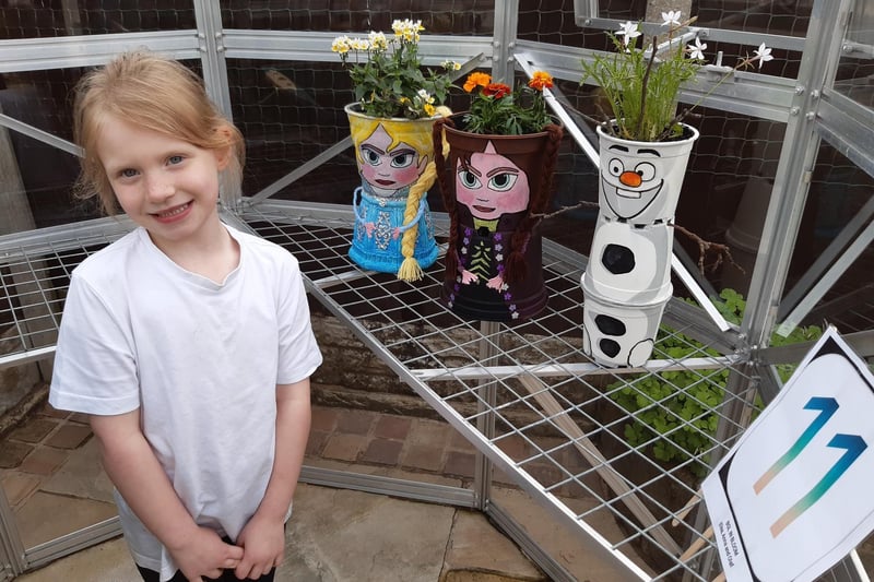 Cadence Cockburn, with three of the 59 plant pots in the school's fund-raising  Brindle Gregson Lane in Bloom Trail