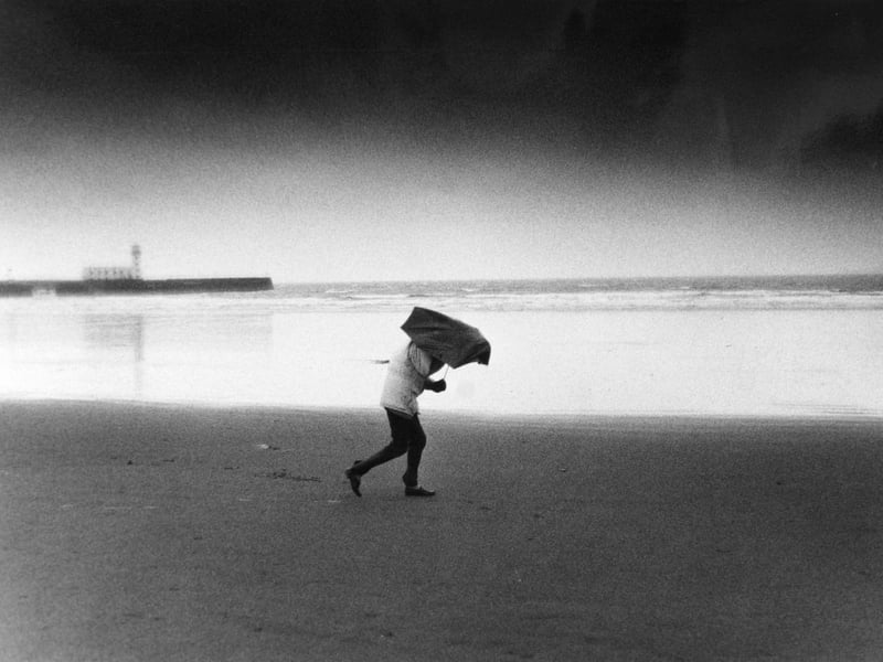 It may have been 30 years ago but people were still getting caught in drizzly weather on the beach.