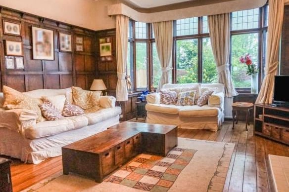 From here is the spacious lounge, which also retains the original panelling and oak wood flooring. The focus on the room is the feature fireplace as well as the wide bay window, bringing it lots of light and offering views of the front garden.