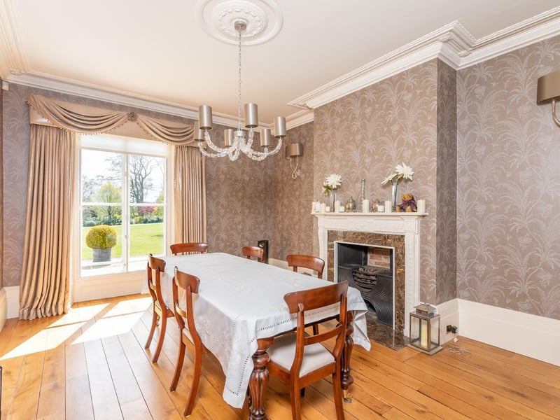 Also in the main wing of the house is the formal dining room which again overlooks the outstanding gardens, and benefits from a feature fireplace and high ceilings perfect for a bespoke chandelier.
