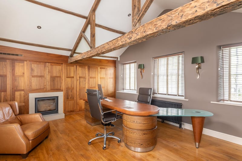 Across from the house is a home office finished in fine walnut panelling, with original beams and an integral contemporary fireplace. It is spacious enough for a large desk and armchair.