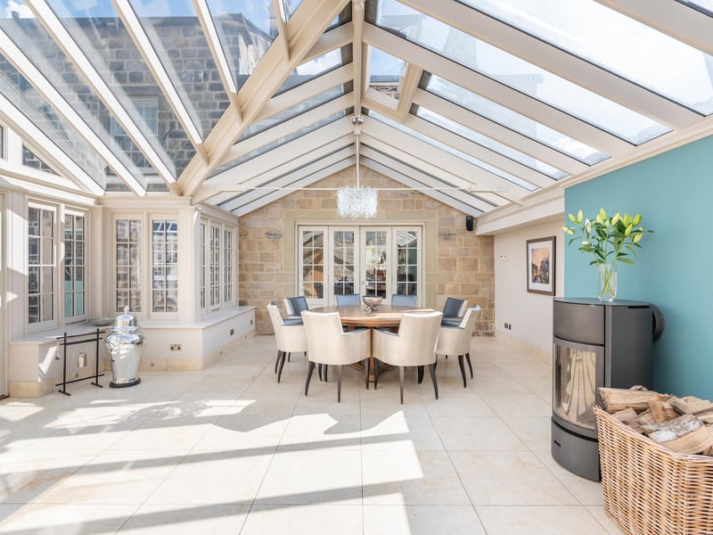 The open plan kitchen dining area is described as "the hub of the house". It incorporates a spacious orangery, which extends the dining/living area to the guest wing and enhances natural light levels. Within the orangery is a large dining table, as well as a wood burning fireplace, making it the perfect place to relax in any weather.