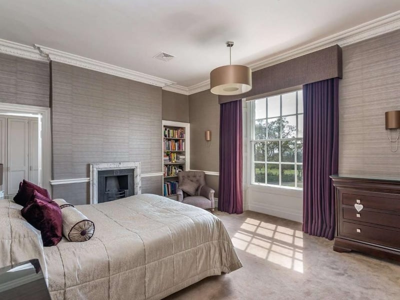 Upstairs on the first floor is the main master bedroom, complete with its own dressing room and bathroom. The tastefully decorated room is very spacious with windows overlooking the gardens.