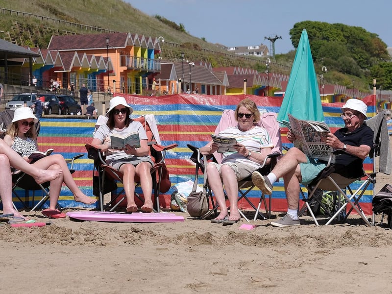 A family reads in the sun