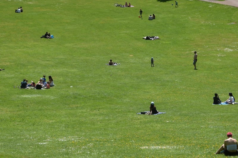 People enjoying the sun in Avenham Park