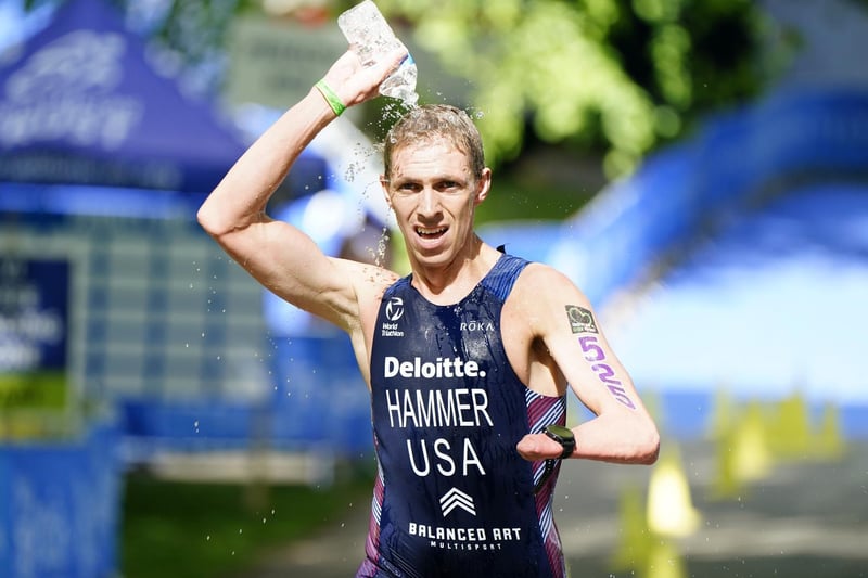 Chris Hammer pours water over himself during the running stage of the AJ Bell 2021 World Triathlon Para Series race in Roundhay Park, Leeds. (photo: PA Wire/ Danny Lawson)