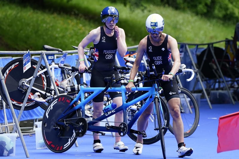 Alison Peasgood (left) with her guide in the cycling transition zone during the AJ Bell 2021 World Triathlon Para Series race in Roundhay Park, Leeds (photo: PA Wire/ Danny Lawson)