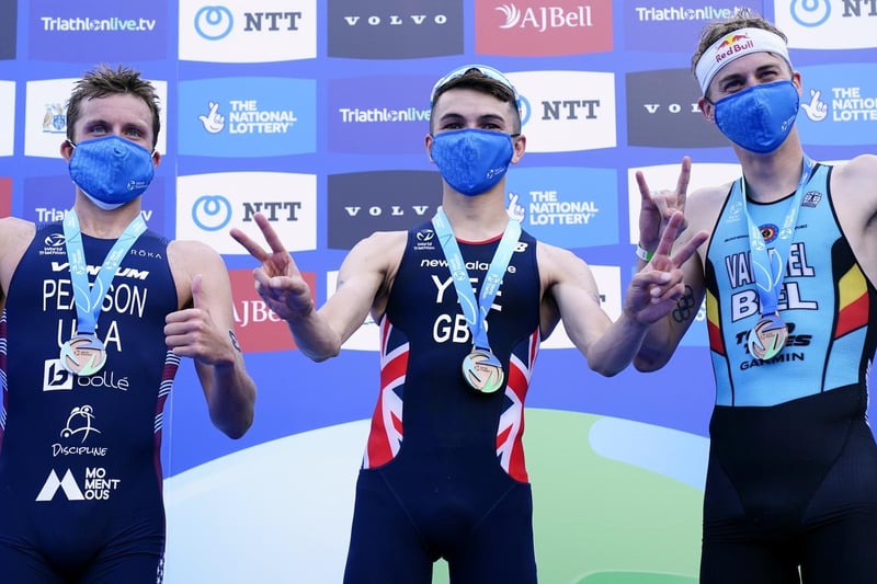 Great Britain's Alex Yee (centre) celebrates winning The AJ Bell 2021 World Triathlon Championship Series Mens Race alongside second placed USA's Morgan Pearson (left) and third placed Belgium's Marten Van Riel (photo: PA Wire/ Danny Lawson)