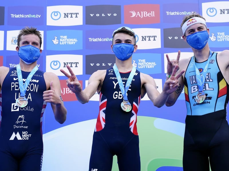 Great Britain's Alex Yee (centre) celebrates winning The AJ Bell 2021 World Triathlon Championship Series Mens Race alongside second placed USA's Morgan Pearson (left) and third placed Belgium's Marten Van Riel (photo: PA Wire/ Danny Lawson)