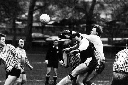 Smiths Arms 'keeper Stuart Padgett palms the ball off the head of Lupset's Ken Winpenny in a Wakefield League Division Four game.