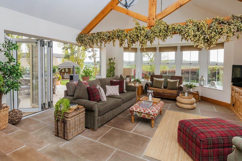 A lovely bright space in which to relax, with doors out to the patio area and garden