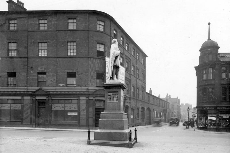The statue of H.R. Marsden is pictured in this photo of Woodhouse Lane and Merrion Street junction in October 1937. Premises on Woodhouse Lane are The General Motor and Tyre Co Ltd. On the opposite corner is H W Poole boot maker.