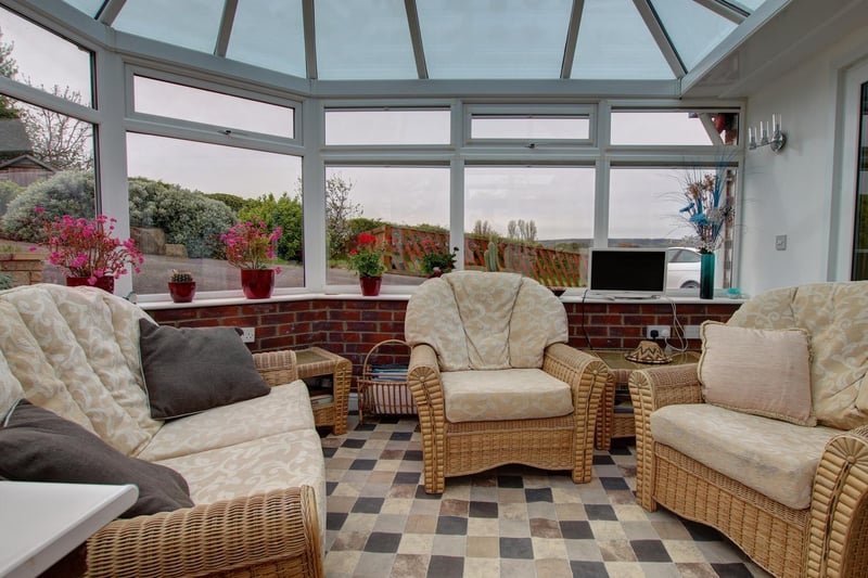 The comfortable conservatory, that looks out over the garden and beyond