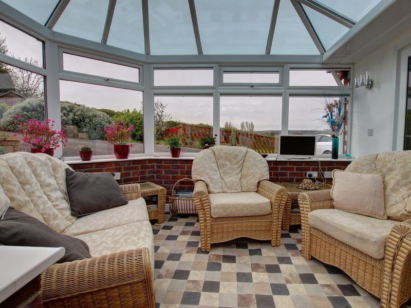 The comfortable conservatory, that looks out over the garden and beyond
