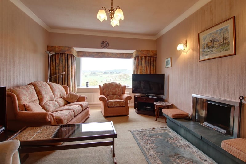 The lounge in Holmefield with its statement fireplace and large picture window