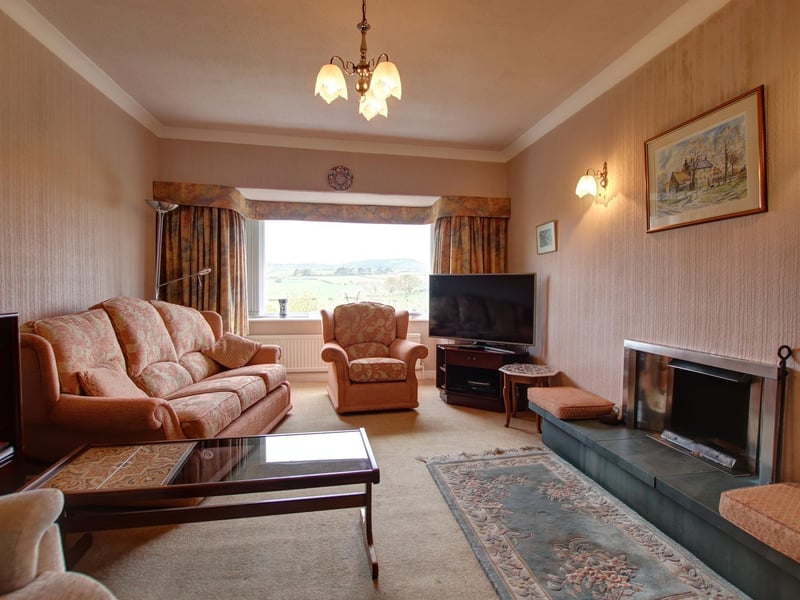 The lounge in Holmefield with its statement fireplace and large picture window