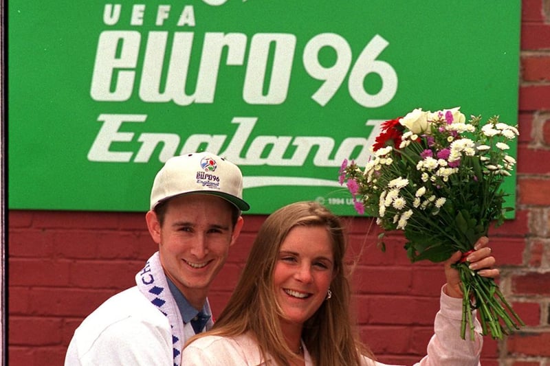 Saying it with flowers. Jonathan Davis and Fay Bourton pictured in front of one of the Euro 96 signs at Elland Road.