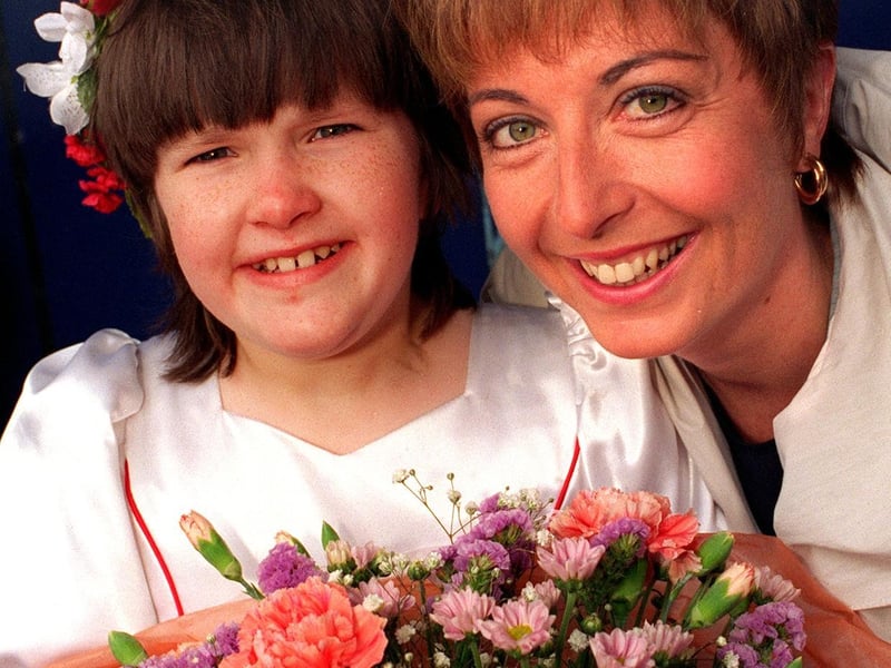 YTV Calendar presenter Gaynor Barnes is presented with a bouquet by Rebecca Bamford after she opened the Carnival in June 1997. Rebecca, a pupil at Green Meadows School, was an attendant to the Carnival Queen.
