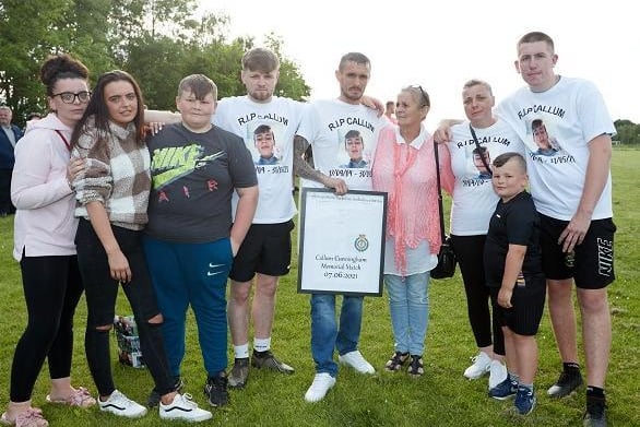 Callum's family with a shirt presented by the Ambulance service