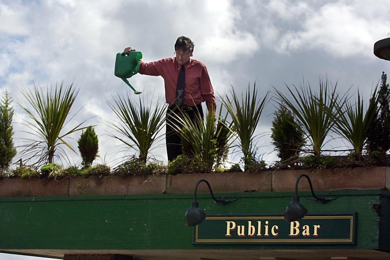 Manager Dave Sim attending to some of the plants at The Broadway pub on Dewsbury Road.