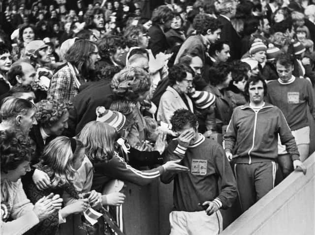 Consolation from the fans for upset Latics captain Albert Jackson followed by Graham Oates and Billy Sutherland as they come down with their runners-up medals after losing 2-1 in extra time to Scarborough in the FA Trophy final at Wembley on Saturday 28th of April 1973