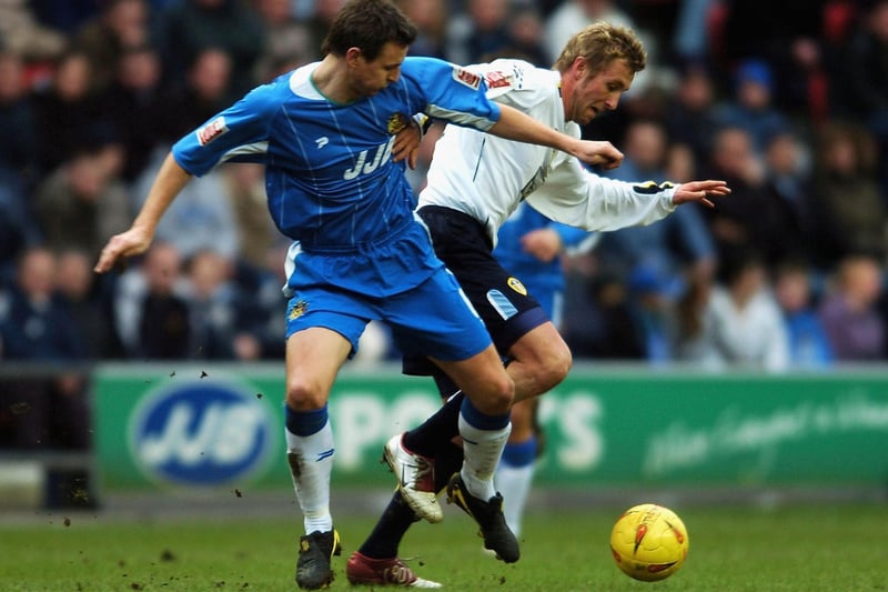 Rob Hulse battles for the ball with Wigan Athletic's Leighton Barnes during the Championship clash at the JJB Stadium in February 2005.