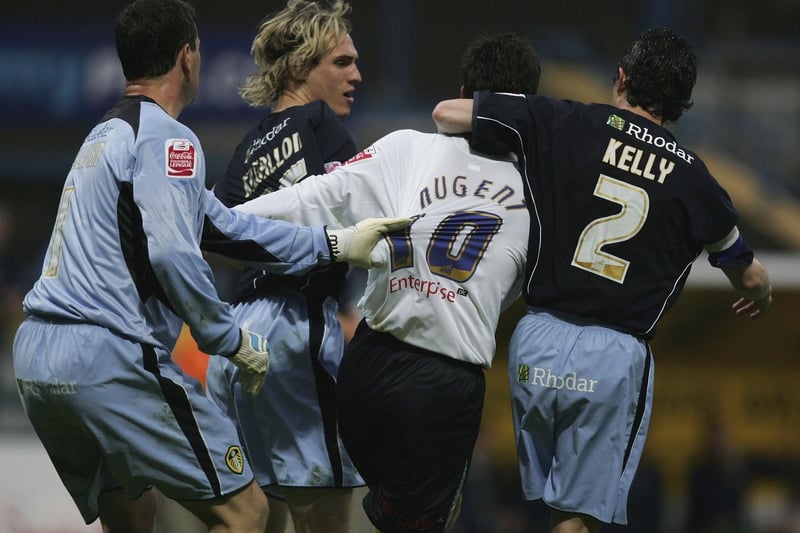 Preston North End striker David Nugent is held back by Leeds United goalkeeper Neil Sullivan (left) and Gary Kelly (right) after a clash with Matthew Kilgallon (background).