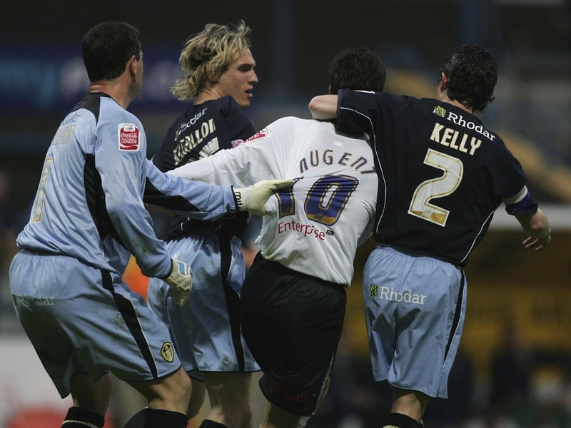 Preston North End striker David Nugent is held back by Leeds United goalkeeper Neil Sullivan (left) and Gary Kelly (right) after a clash with Matthew Kilgallon (background).