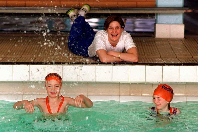 Young swimmers took the plunge at Morley Leisure Centre to help raise £200,000 to send athletes to 1996 Olympics. Pictured is former Olympic swimmer Suki Brownsdon with Jonathan. Plows and Hannah Fletcher