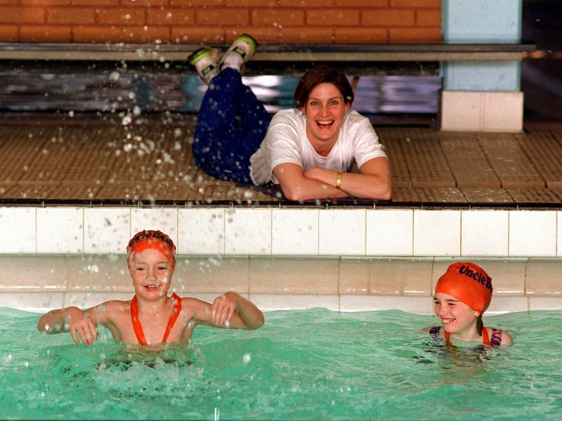 Young swimmers took the plunge at Morley Leisure Centre to help raise £200,000 to send athletes to 1996 Olympics. Pictured is former Olympic swimmer Suki Brownsdon with Jonathan. Plows and Hannah Fletcher