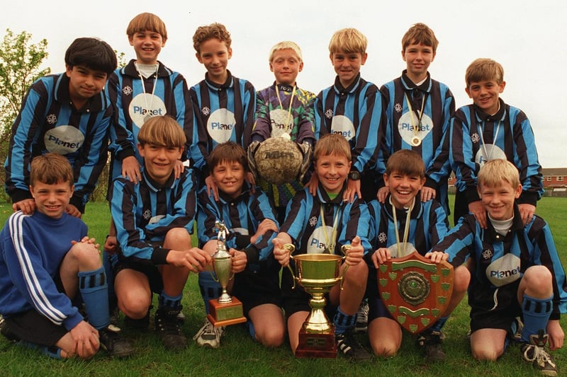 Morley Cross Hall Junior School U-11s football team pictured with their trophies in May 1996.