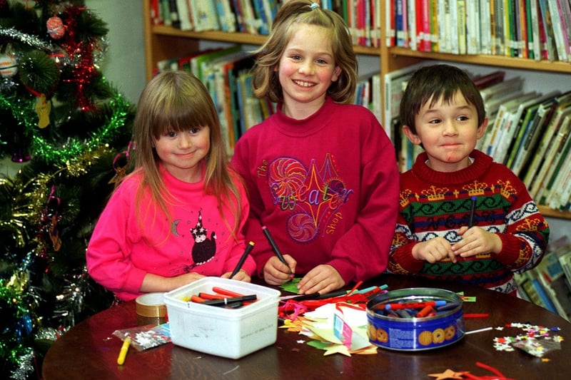 Children at Morley Library were making their own Christmas decorations in December 1996. Pictured, from left,  are Amanda Mace, Laura Walker and William Gray.