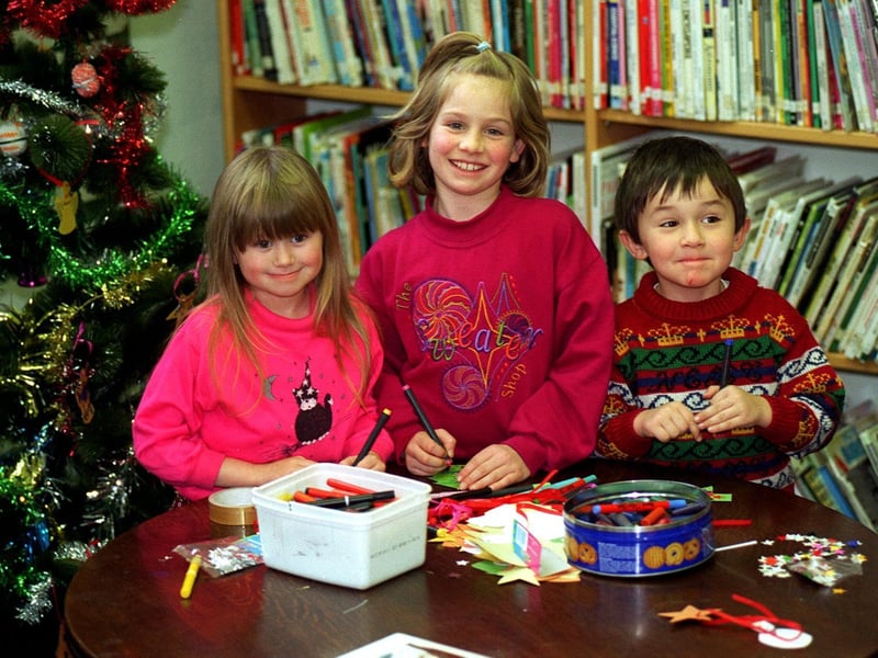 Children at Morley Library were making their own Christmas decorations in December 1996. Pictured, from left,  are Amanda Mace, Laura Walker and William Gray.