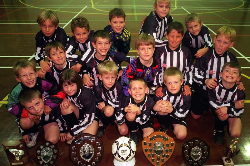 This is Churwell Lions U-9s football team who were celebrating success in November 1996.