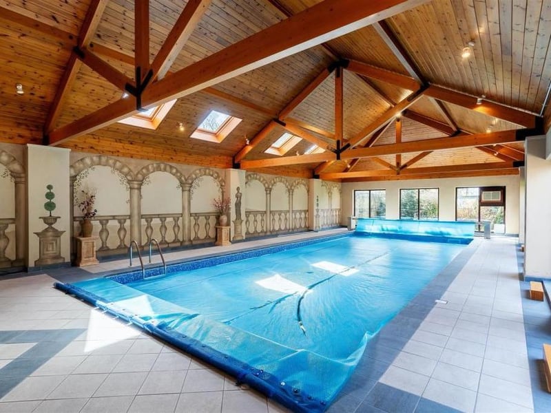 A great bonus to the property is its large swimming build. The large poolmeasures approximately 13m x 5m and there aremultiple sets of tall windows and french doors, which open into the garden, flood the room with natural light, along with several velux windows inset to the fantastic timber open pitched roof, which boasts exposed rafters and beams. It features decor with 'Greek' style wall murals.