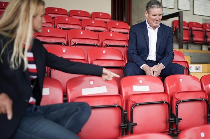 Labour leader Sir Keir Starmer and the party's candidate Kim Leadbeater take a seat during the visit to Batley Bulldogs' stadium. Getty Images