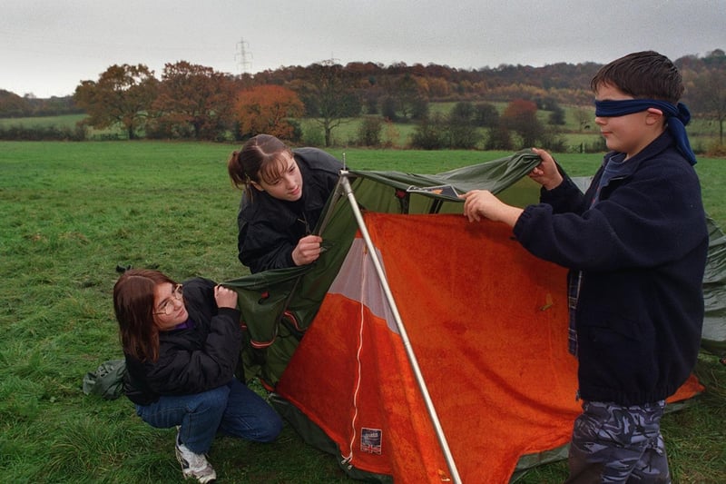A Youth Action Challenge Day was held at Oakwood Hall in November 1997. Pictured trying to put up a tent blindfolded are Donna Brook, Suzannah Gledhill and Matthew Wilkinson.