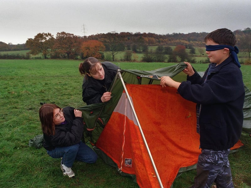 A Youth Action Challenge Day was held at Oakwood Hall in November 1997. Pictured trying to put up a tent blindfolded are Donna Brook, Suzannah Gledhill and Matthew Wilkinson.