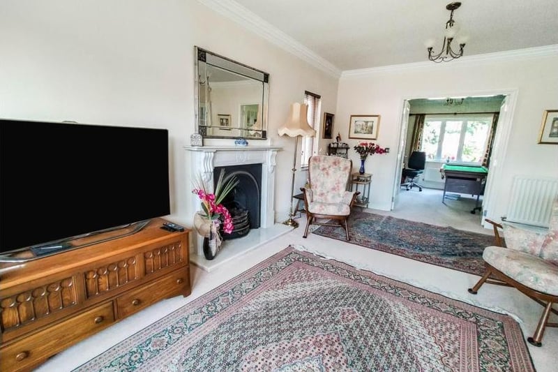 The formal lounge very spacious and benefits from a bay window to the front and a stunning marble fireplace.