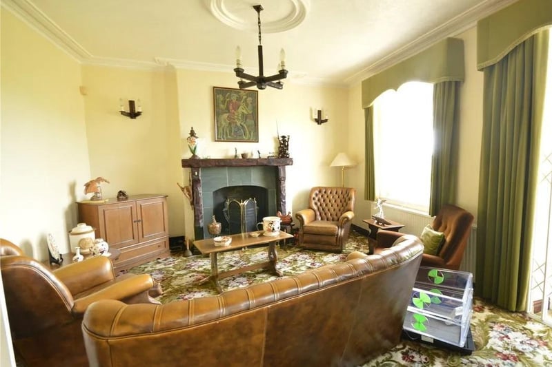 A cosy sitting room with feature fireplace within the house