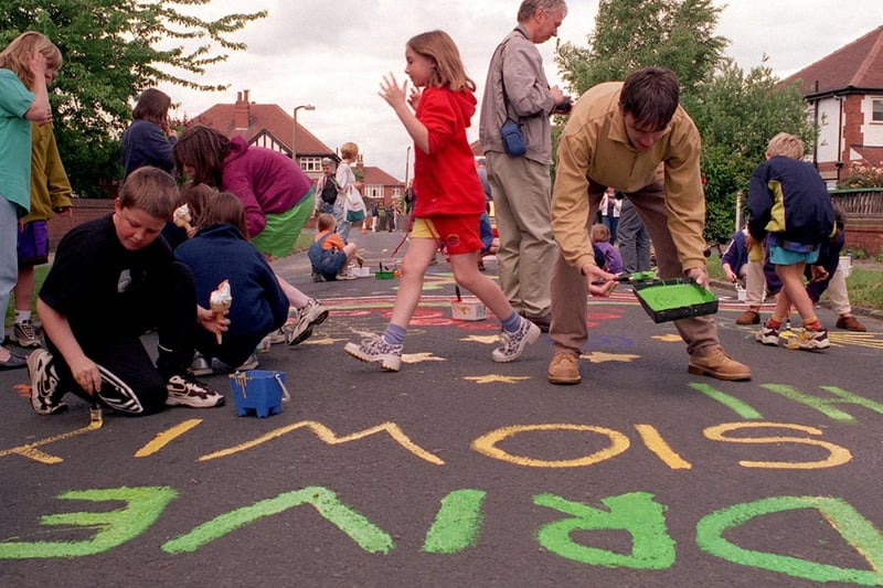 Residents of Headingley Mount write slogans on the road to remind drivers to slow down.