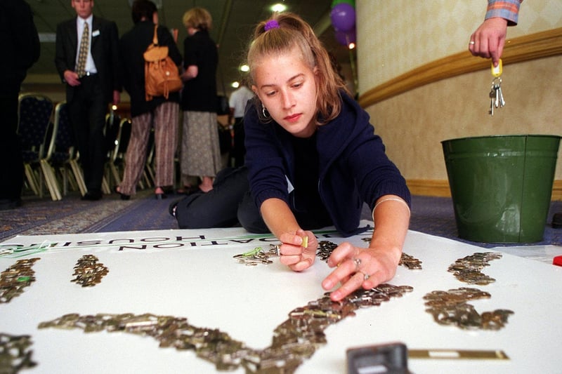 Freelance artist and writer Kath Jones works on a 3D wall picture made from 3,000 door keys at the launch of Foundation Housing, formerly Timble Housing Project in Leeds.