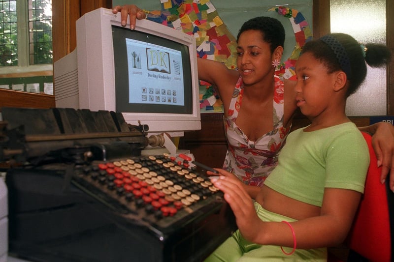 'From Steam To Microchips' exhibition was held at Armley Library in August 1996. It was opened by Coun Alison Lowe who shows young Laura Marshall the contrast between an early electric typewriter and a modern day computer.